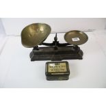 A set of cast iron kitchen scales complete with weights and brass pans.