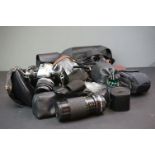 A collection of camera's and photographic accessories to include an Olympus OM-10 35mm SLR camera.