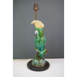 A table lamp in the form of a Majolica Cockatoo mounted on a wooden base 51 cm to top of bulb