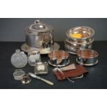 A collection of silver plated wine bottle coasters and a biscuit holder with dog finial together