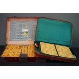 Two leather cased Mahjong sets together with a leather cup holder and a group of vintage penknives.