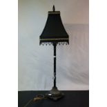 A bamboo style table lamp with black shade.