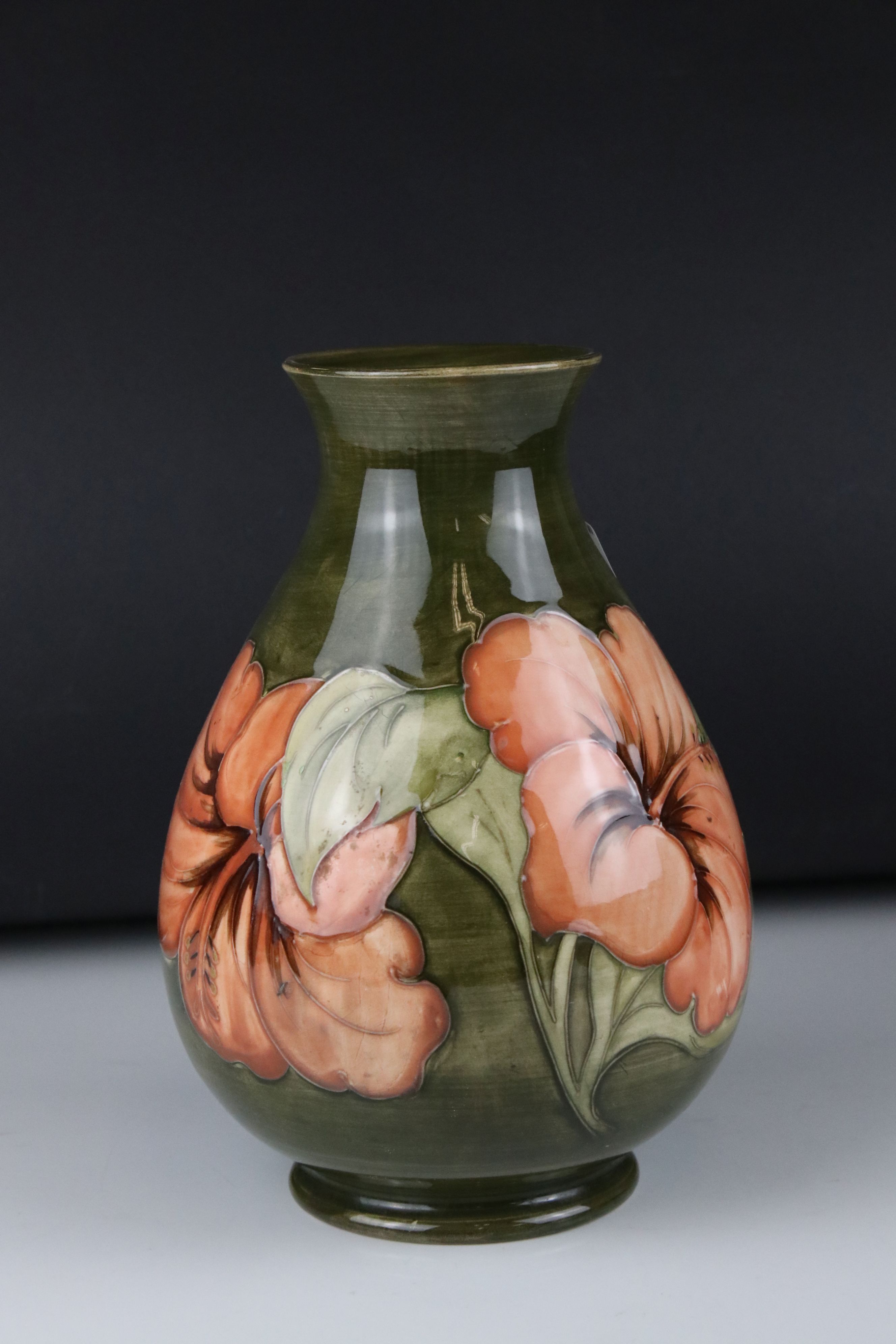 Moorcroft Vase in the Hibiscus pattern on green ground, impressed Moorcroft mark to base and also
