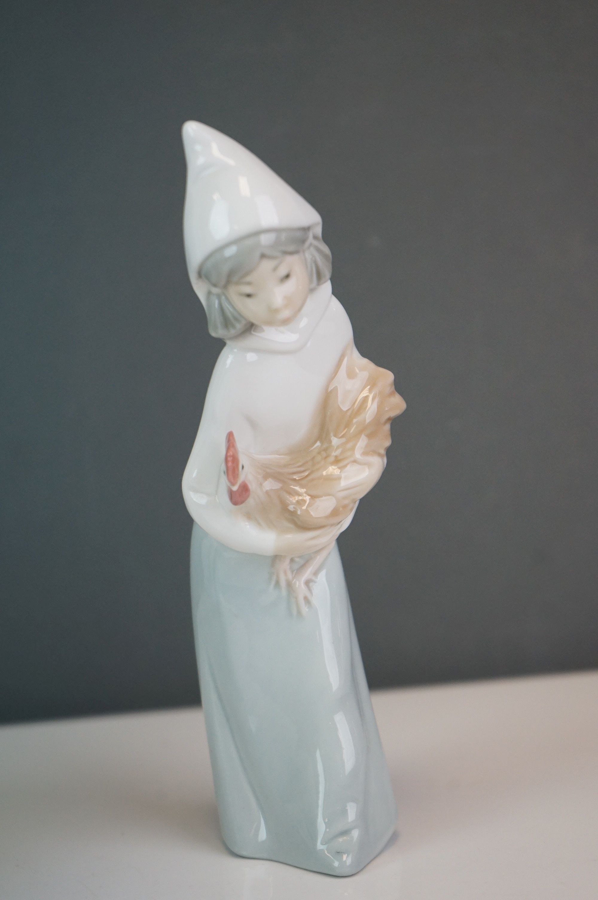 A Lladro bust of a woman in a cowl, together with a girl holding a hen (2) - Image 6 of 9