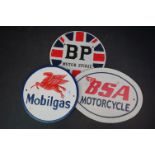 Three reproduction cast iron signs to include BSA motorcycles.