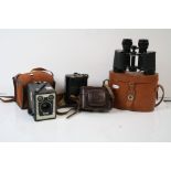 A pair of Kershaw field binoculars in original leather case together with three vintage cameras.