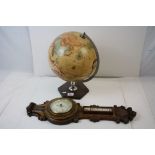 A contemporary desktop globe together with a vintage wooden wall hanging barometer.