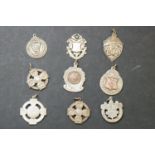 A collection of hallmarked silver Albert fob medals many with Irish provincial hallmarks.