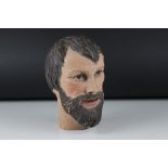 A carved wooden bust of a bearded man 22 cm tall.