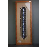 A framed and glazed Chinese blue and white ceramic scroll or parchment holder.