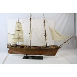 A kit built wooden model sailing ship on stand.
