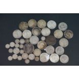 A collection of coins to include British pre-decimal silver examples include a 1887 Queen Victoria