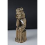 Carved wooden figure of an ancient seated man in contemplation, 20 cm tall.