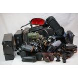A large collection of vintage and contemporary cameras and binoculars.