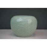A Chinese Celadon vase with Dragon Decoration character marks to underside.