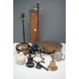 A group of metal ware to include two dinner gongs one made from a shell case two cast iron candle