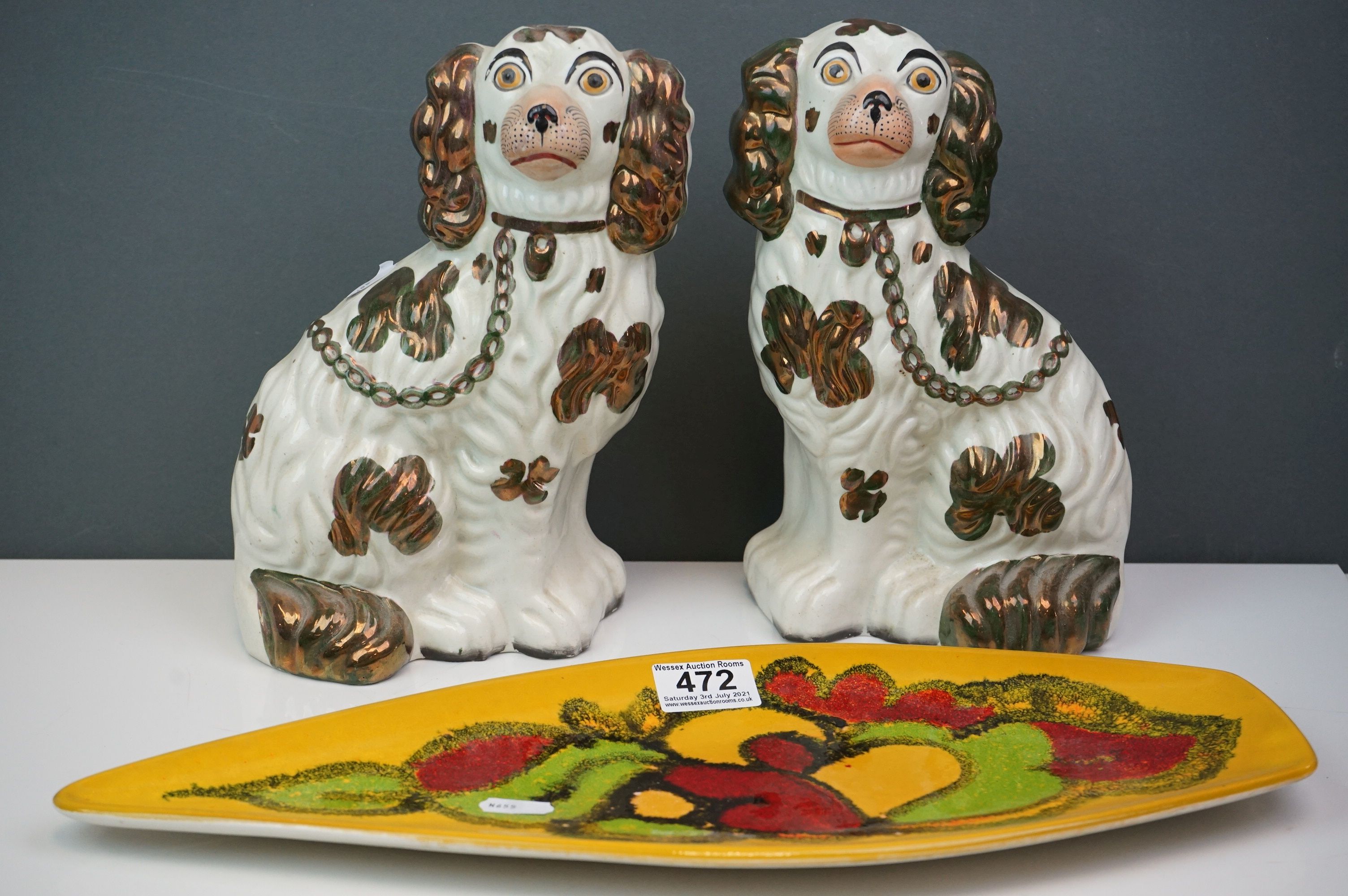 A 1970s Poole Pottery Delphis pattern dish together with a pair of lustre Staffordshire dogs.