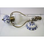 A antique gilt metal and ceramic ceiling light with blue and white floral decoration.