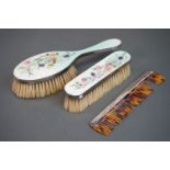 A fully hallmarked sterling silver and enamel dressing table brush set with floral decoration.