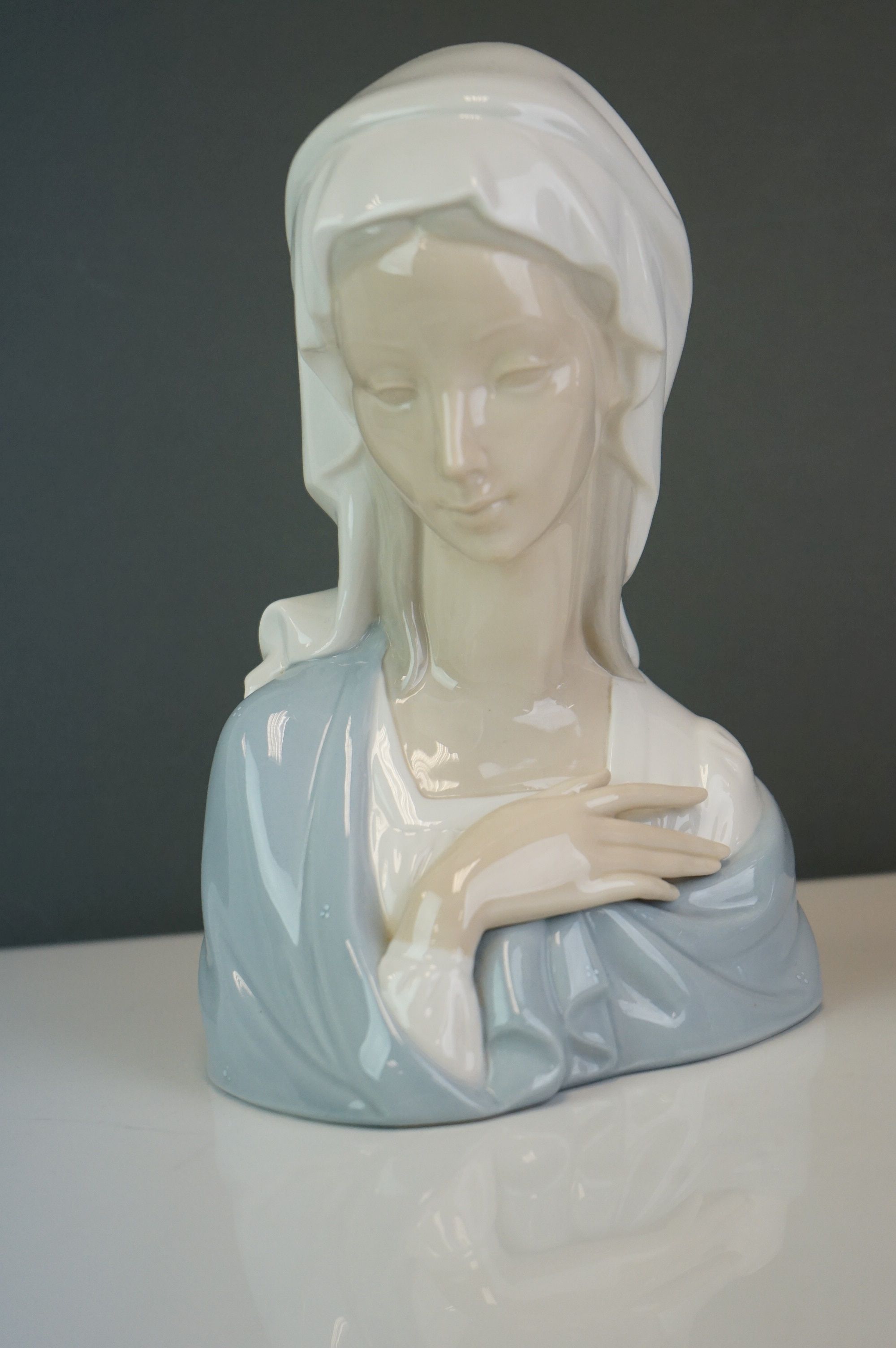 A Lladro bust of a woman in a cowl, together with a girl holding a hen (2) - Image 2 of 9