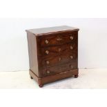 19th century Flamed Mahogany Chest of Four Long Drawers, with canted corners and raised on bun feet,