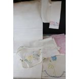 A collection of vintage linen to include napkins and table cloths.