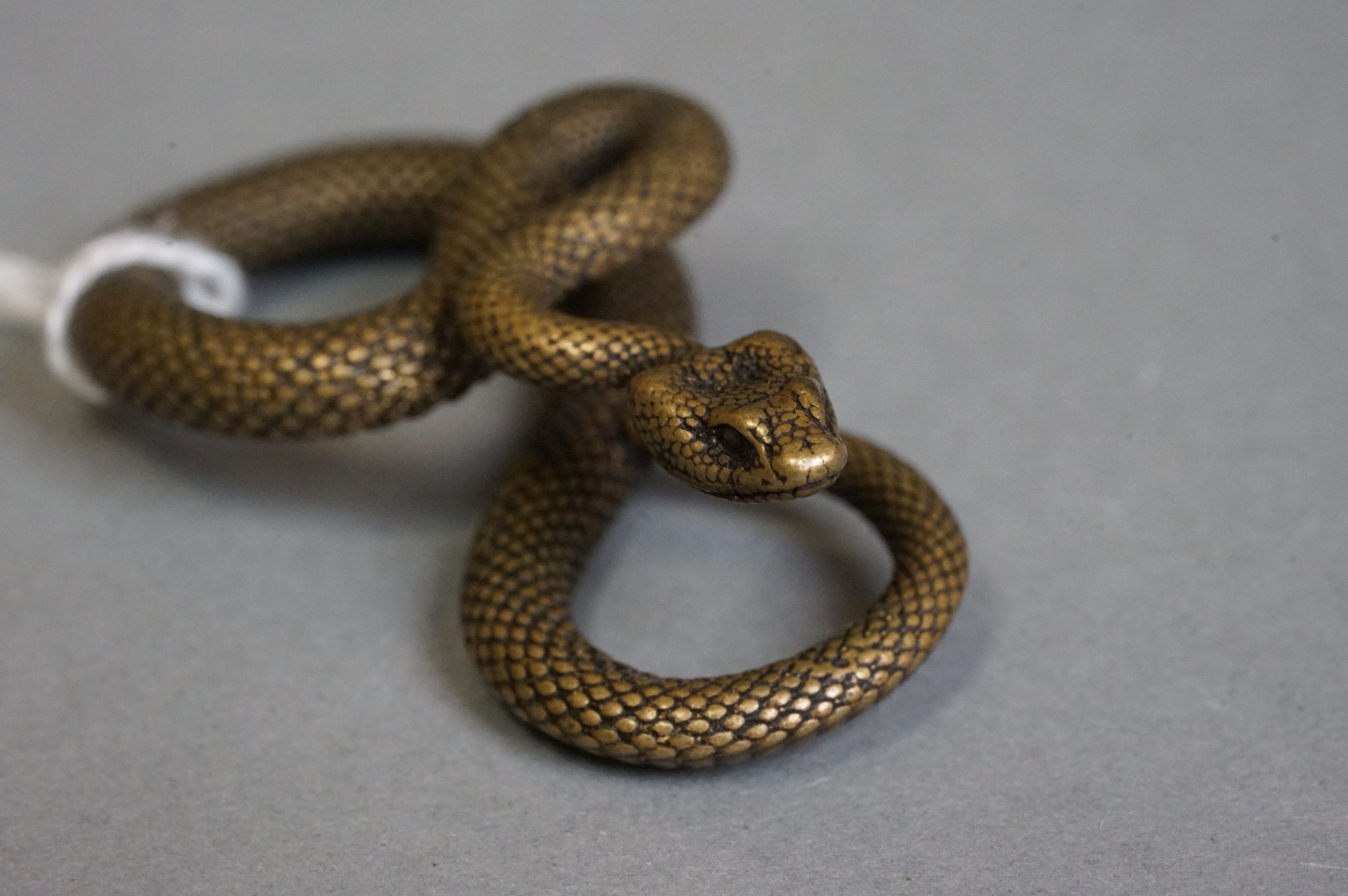 A small metal figure of a viper snake. - Image 4 of 4