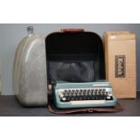 Two cased portable typewriters together with a boxed Kodak film projector.