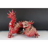 A 20th century ceramic red ground Oriental dragon, 35 cm long x 33 cm tall.