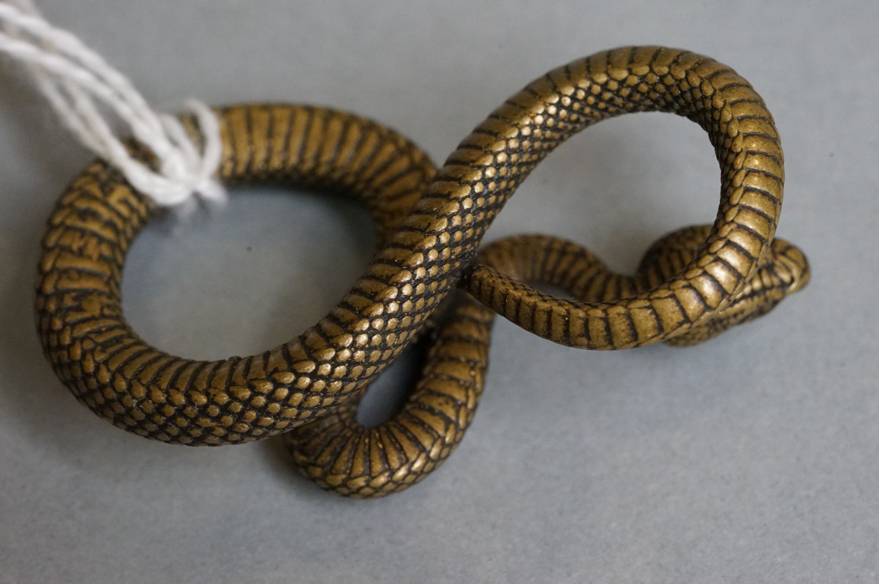 A small metal figure of a viper snake. - Image 3 of 4