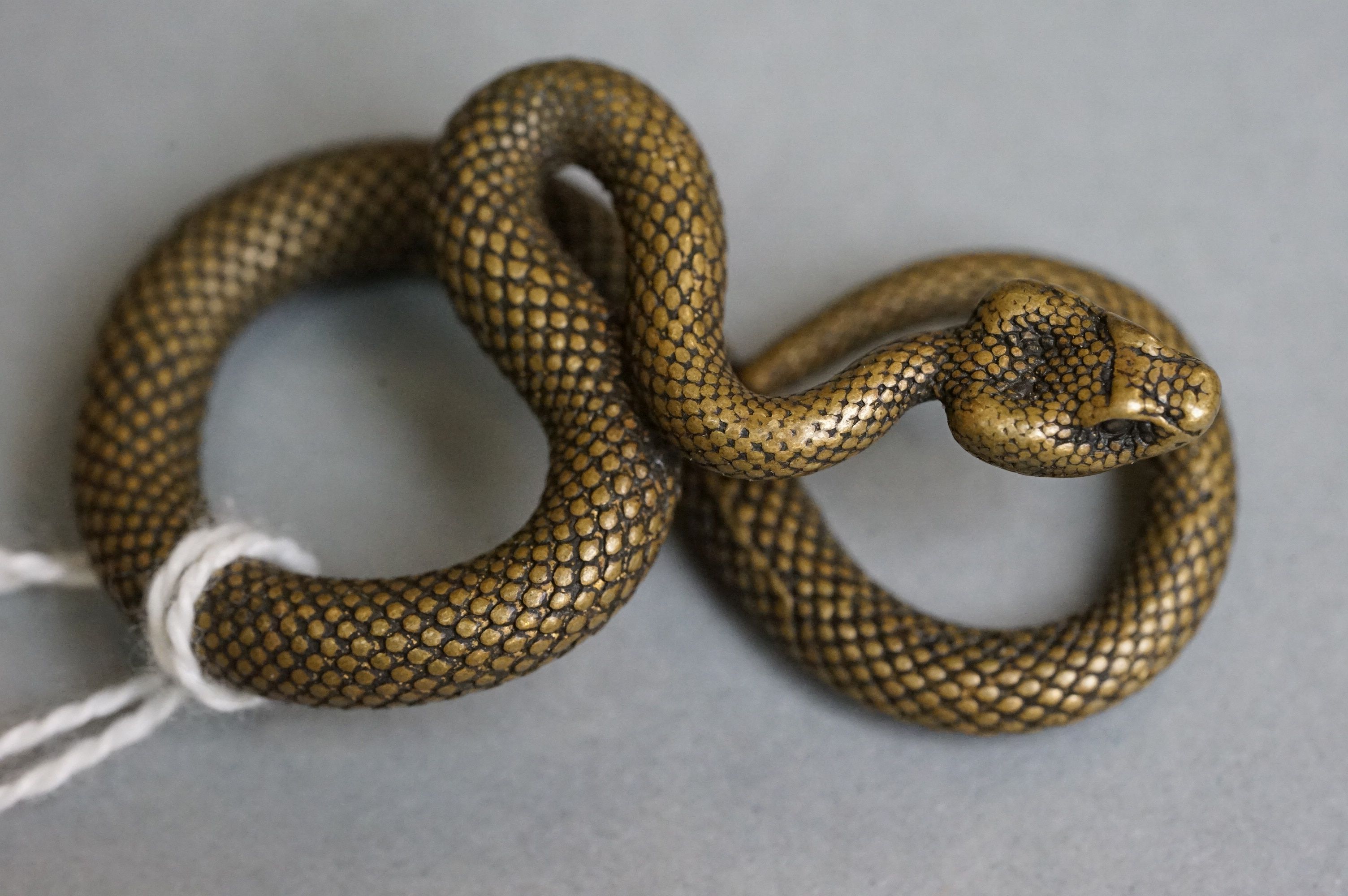 A small metal figure of a viper snake. - Image 2 of 4