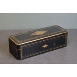 An ebonised wooden box with brass string decoration.