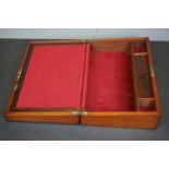 A mahogany writing slope with fitted interior and brass inlay.