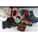 A box of mixed collectables to include ladies gloves, tea towels, advertising tins and story