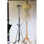 A dress maker mannequin together with a wrought iron lamp base.
