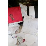 A collection of vintage linen to include napkins, tea towels and tables cloths.