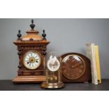 An ornate wooden clock, a mantle clock, and an anniversary clock together with two clock books.