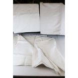 A collection of vintage white linen table cloths.