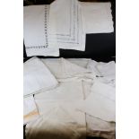 A collection of vintage white linen table cloths.