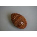 An ornate carved treen nutmeg holder with screw thread.