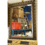 An antique gilt framed mirror with bevelled edge.