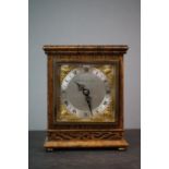 A wooden cased mantle clock marked G.H. Pressley & Sons, Elliott, London.