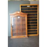 A contemporary glazed display cabinet together with one other similar.