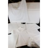 A collection of vintage white linen table cloths.