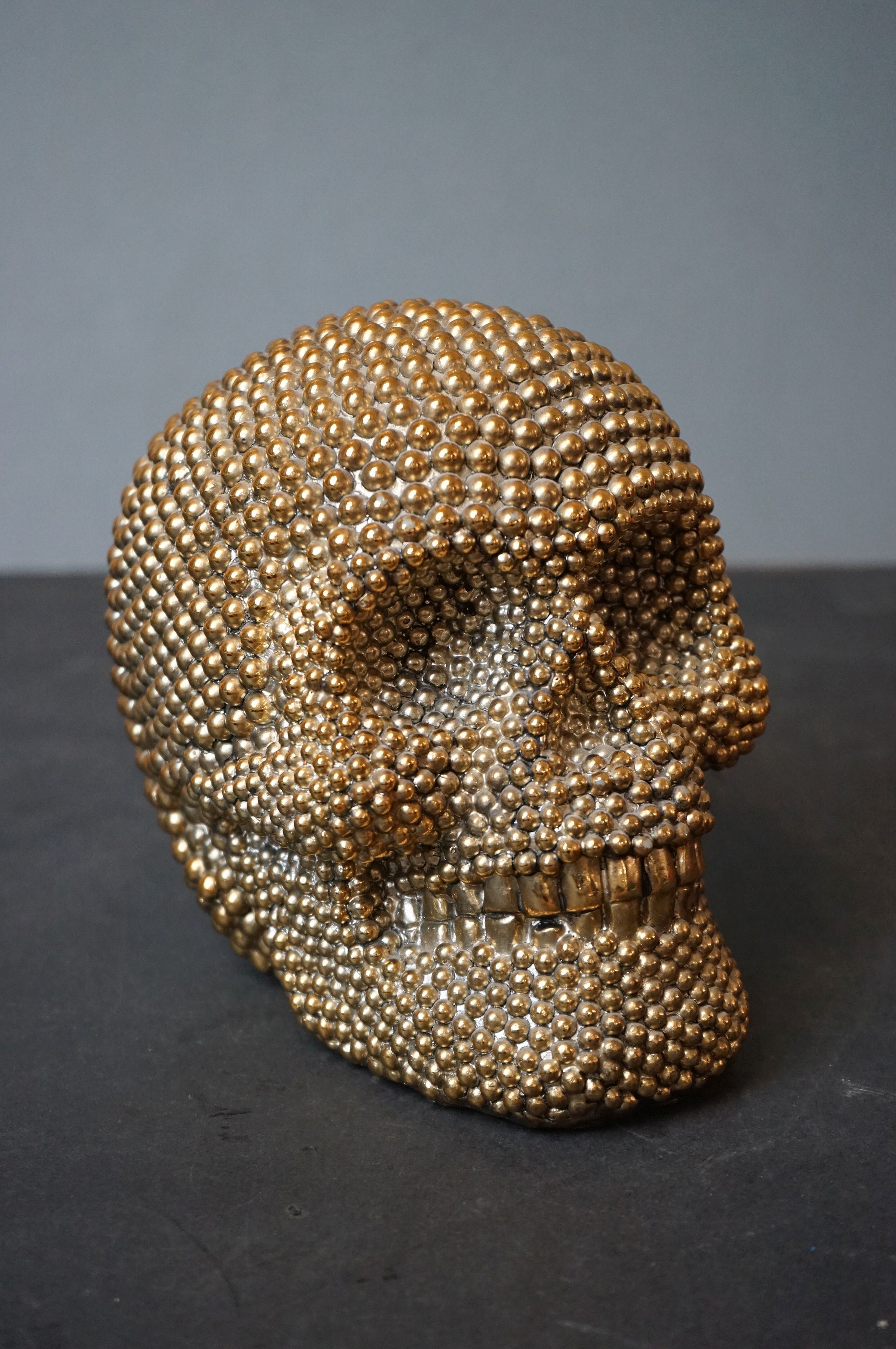 A decorative resin Golden skull ornament.