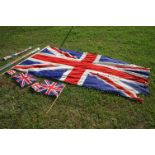 A selection of of Union Jack flags on green metal poles.