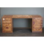 An oriental wooden desktop Pedestal desk with five outer drawers and two drawers behind door, stands