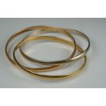 A ladies 18ct gold trio bangle in white, yellow and rose gold, marked 18ct / 750.