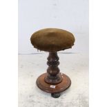 Victorian Mahogany Revolving Piano Stool raised on turned column supports, circular platform base