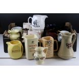 A quantity of vintage ceramic pub advertising water jugs.
